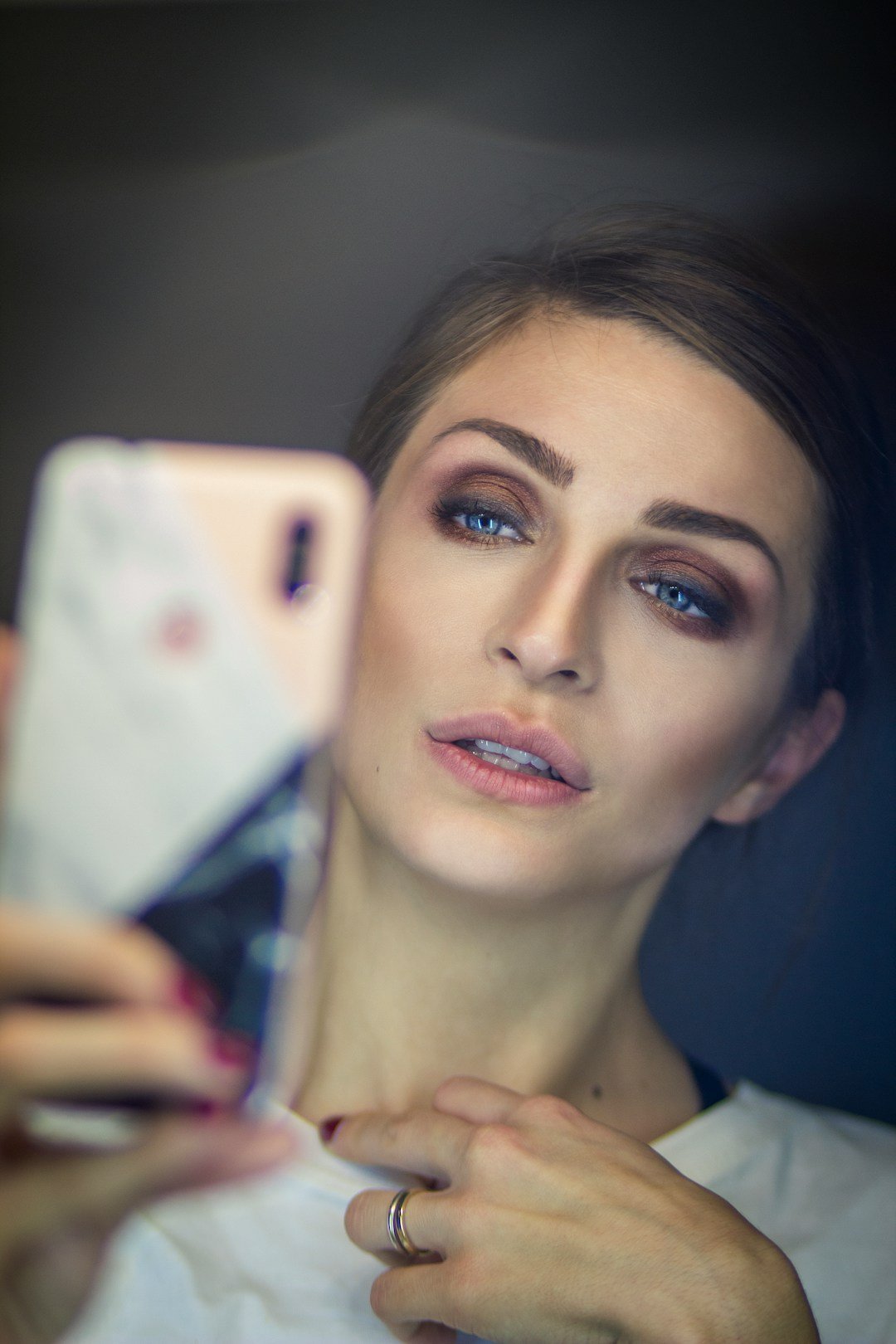 Adult woman smiling while using a smartphone for online communication