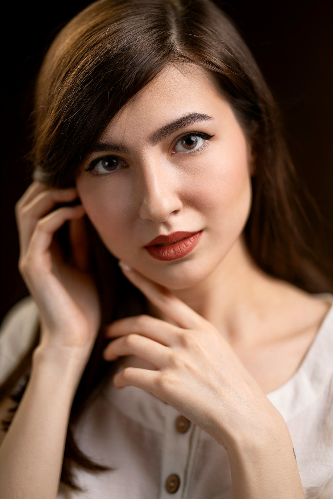 Adult woman smiling while messaging on a smartphone outdoors